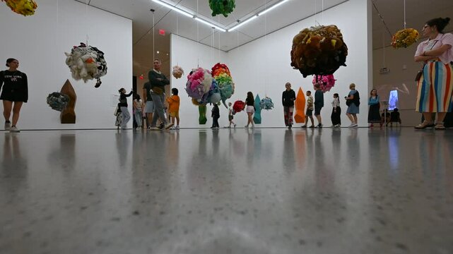 New York City, USA, August 20, 2024. MoMA, Museum of Modern Art. A new exhibition featuring clouds made from recycled fabrics, people walk around the room interacting with the work.