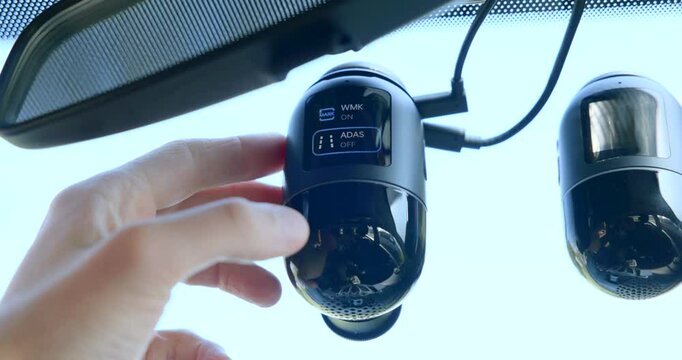 A Hand Activates the ADAS Feature on a 70mai Omni 360-degree Rotating Dash Cam - Close Up