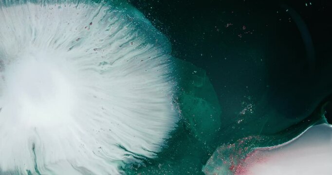 Alcohol ink is creating stunning abstract shapes while flowing and mixing with white paint, resulting in a mesmerizing fluid art composition with intricate details and textures, microscopic view