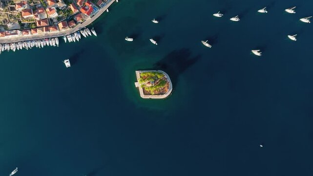 Drone circles around small Island of Lazareto near Vathy in Ithaca, Sailing boats in harbour