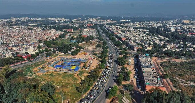 Aerial view of an Indian City and agricultural fields near the Delhi-Chandigarh Highway in Punjab, India. Natural texture for the background. The picturesque countryside of India. Healthy food concept