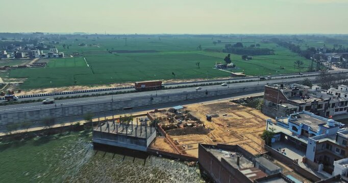 Aerial view of an Indian City and agricultural fields near the Delhi-Chandigarh Highway in Punjab, India. Natural texture for the background. The picturesque countryside of India. Healthy food concept