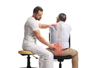 Chiropractor treating a mature man for backpain and stiff spine
