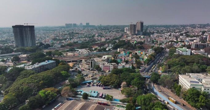 Daytime aerial view of the outer of the Kempegowda Bus Station in Bengaluru. View of the majestic bus stand and residential rooftops of the metropolitan city of Bangalore