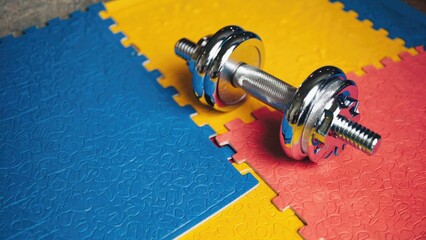 A dumbbell with adjustable bolts.