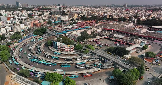 Daytime aerial view of the Kempegowda Bus Station in Bengaluru. View of the majestic bus stand with buses parked and moving to different spots in metropolitan city of Bangalore