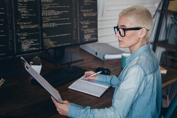 Young professional woman working on coding project in a casual office environment