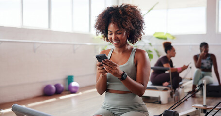 Gym, happy woman and application with phone for fitness, health club or streaming for reel. Online, female person and smile with mobile for exercise video, social media or virtual tutorial for cardio