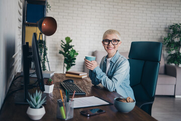 Smiling Professional Woman in a Modern Home Office Setting Working on Computer