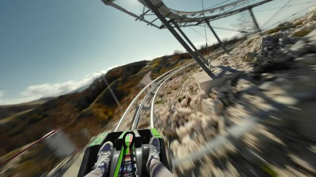 Alpine roller coaster in Montenegro, first person view. Lovcen mountain and Bay of Kotor view. Summer, sunny day with a blue sky. 