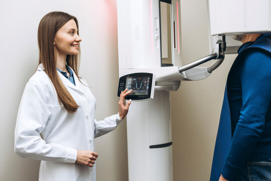 Female doctor taking image 3d scanner tomography of teeth and jaw in modern laboratory dental clinic