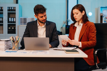 Business team working on a project in the office or reviewing and discussing a business project.