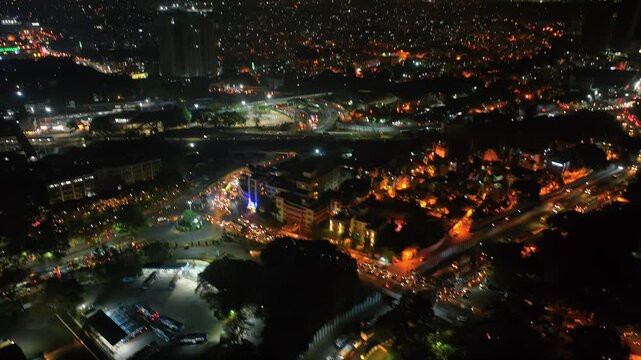 Aerial night view of the bustling city of Bengaluru, Karnataka, Busy roads and a bus station with parked buses in metropolitan city of Bangalore, busy night traffic