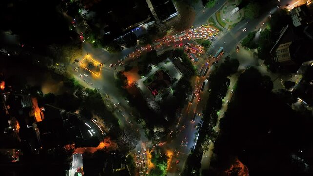 Rotating aerial night view of a Y-point or three-way intersection of roads in Bengaluru, Karnataka, A busy junction of three roads in metropolitan city of Bangalore, busy night traffic