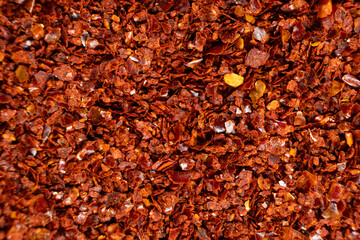 Deep red chili pepper powder close-up texture top view