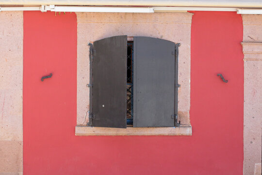 pink red doors and iron windows photographed on a summer day on Cunda Island. handmade and vintage decoration.