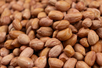 Peanut background, lots of raw peeled brown peanuts close-up.