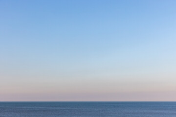 Obraz premium Tranquil seascape with a still blue sea stretching into the horizon