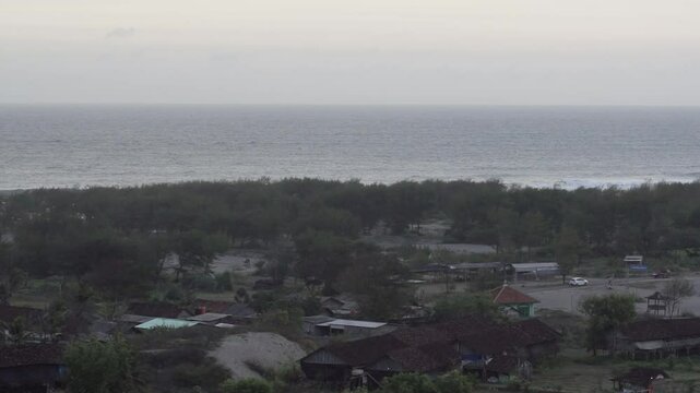 Peaceful Coastal Village Near Sandy Hills and Calm Beach