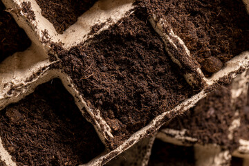 preparing cups for seedlings and filling them with soil before the sowing season close up