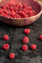 the collected amount of ripe raspberries is red close up, side view