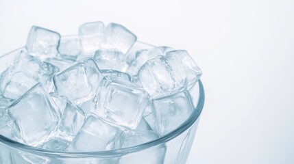 Clear ice cubes in a glass bowl creating an appealing and refreshing look for beverages during warm summer days, isolated on white background