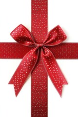Festive red ribbon with charming white polka dots tied in a bow on a pristine white background creating a cheerful holiday ambiance