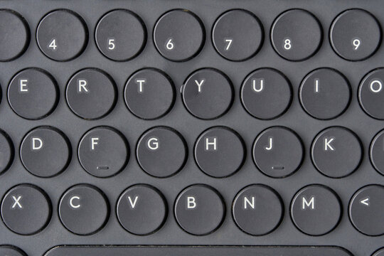 Close up of modern round key black keyboard with letters and numbers in minimalist design. - Powered by Adobe