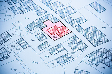 Imaginary cadastral map with buildings - concept with land parcel and vacant plot printed on paper