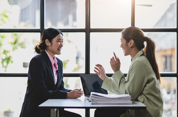 Business woman talking with colleagues in the office.