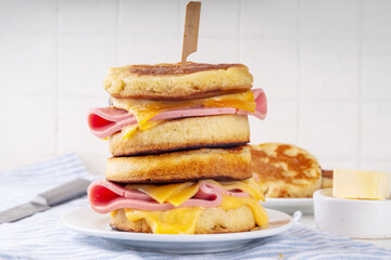 Breakfast crumpet sandwich, british pancake scones burger with cheese and ham