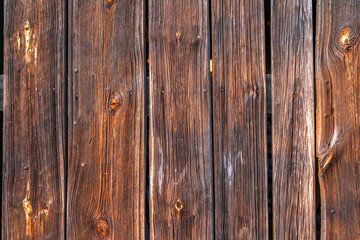 Fototapeta premium Old rotten boards of a farm building, background made of boards, wood as a background