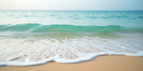 Obraz premium gentle waves lapping on a tranquil sandy beach with soft turquoise water creating a serene coastal atmosphere