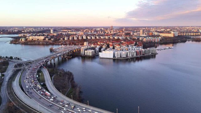 Stockholm, Sweden, aerial rotating view of the city, the E4 motorway, Lilla Essingen and Kungsholmen, beautiful colorful sunset