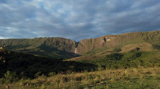 Timelapse of blue sky with moving clouds and distant waterfall in Serra da Canastra, Minas Gerais, Brazil