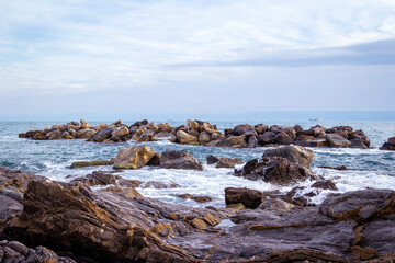 View of the sea cliffs at springtime sunset in Nervi, one of the east neighborhoods of the city of Genoa (Ligurian Region, Northern Italy). The city is famous for its commercial and touristic port.
