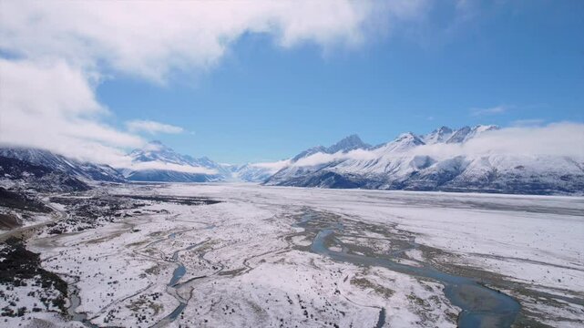 Stunning drone footage of the Tasman River valley in the Mackenzie Basin, South Island, New Zealand. Captured on a clear winter day, showing snow-covered plains, and braided river channels