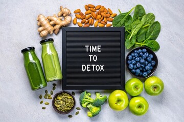 Time to detox letter board quote flat lay with detox products.