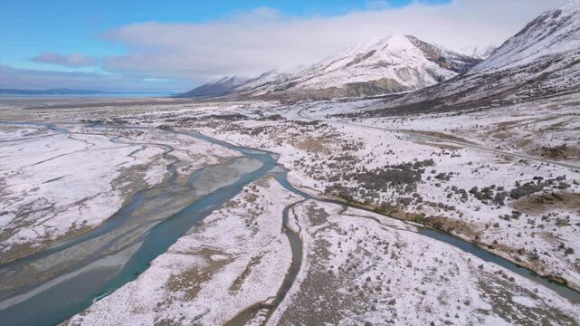 Stunning drone footage of the Tasman River valley in the Mackenzie Basin, South Island, New Zealand. Captured on a clear winter day, showing snow-covered plains, and braided river channels
