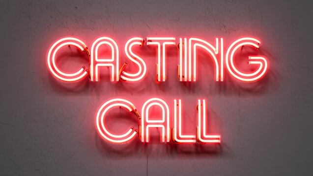 Casting call neon text on a grey wall.