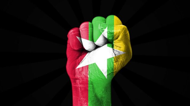Myanmar flag painted on a fist, showing empowerment, freedom, and power, 4k footage