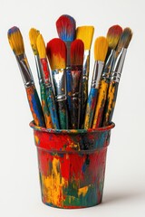Fototapeta premium Vibrant Paintbrushes in Colorful Pot Artistic Still Life Capturing Creativity and Inspiration on White Backdrop Studio Shot