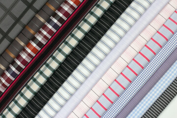 A variety of fabric swatches with checkered and striped designs in vibrant shades, excellent for...
