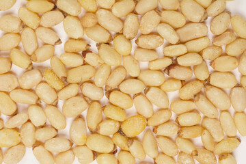 Close-up, full frame shot of pine nuts, showcasing their texture and detail