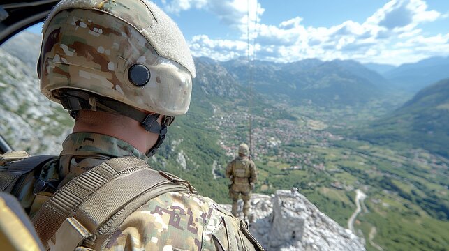 Soldier in Helicopter Surveys Mountainous Valley
