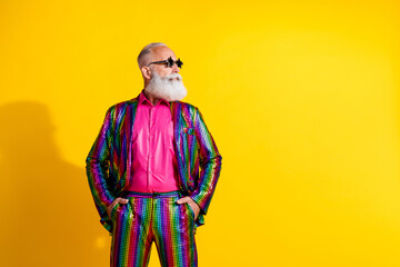 Photo of handsome charismatic old man wear stylish striped bright suit hand hold in pockets theme...
