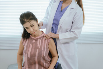 Fototapeta premium A female doctor is giving physical therapy to an elderly woman.