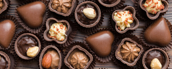 Different kinds of chocolates on colored table close-up. Top View and Flat Lay