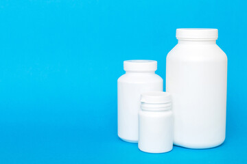 supplement pills with medicine bottle health care and medical top view. Vitamin tablets. Top view mockup bottle for pills and vitamins with green leaves, natural organic bio supplement, copy space