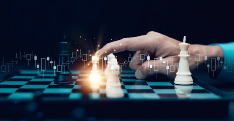 Business strategy and decision-making concept. A person moves a chess piece on chessboard with futuristic network connections, symbolizing leadership, planning, and competitive analysis in business.